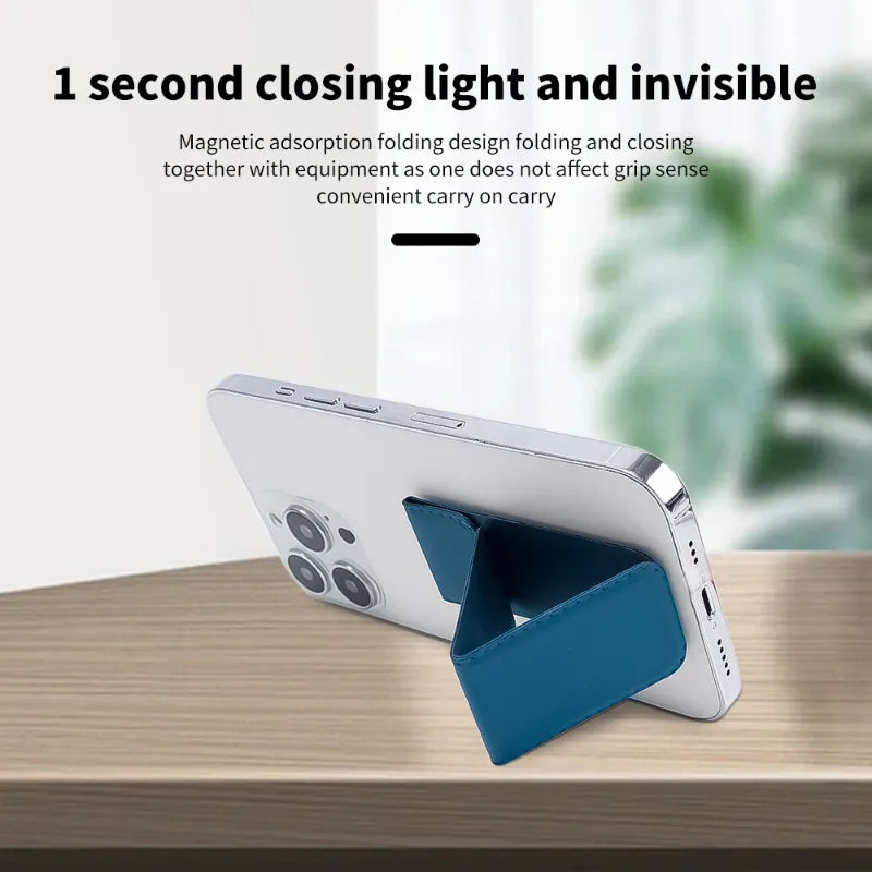 A blue magnetic folding phone stand holding a silver smartphone on a wooden table, with marketing text at the top describing its quick folding and invisible closing light feature.